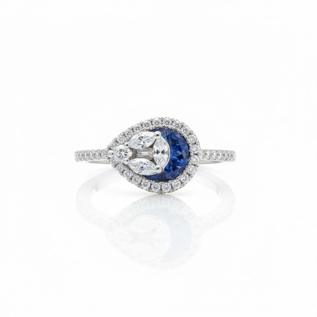 Maison Leininger 18K white gold ring with sapphire center surrounded by marquise and round diamonds.