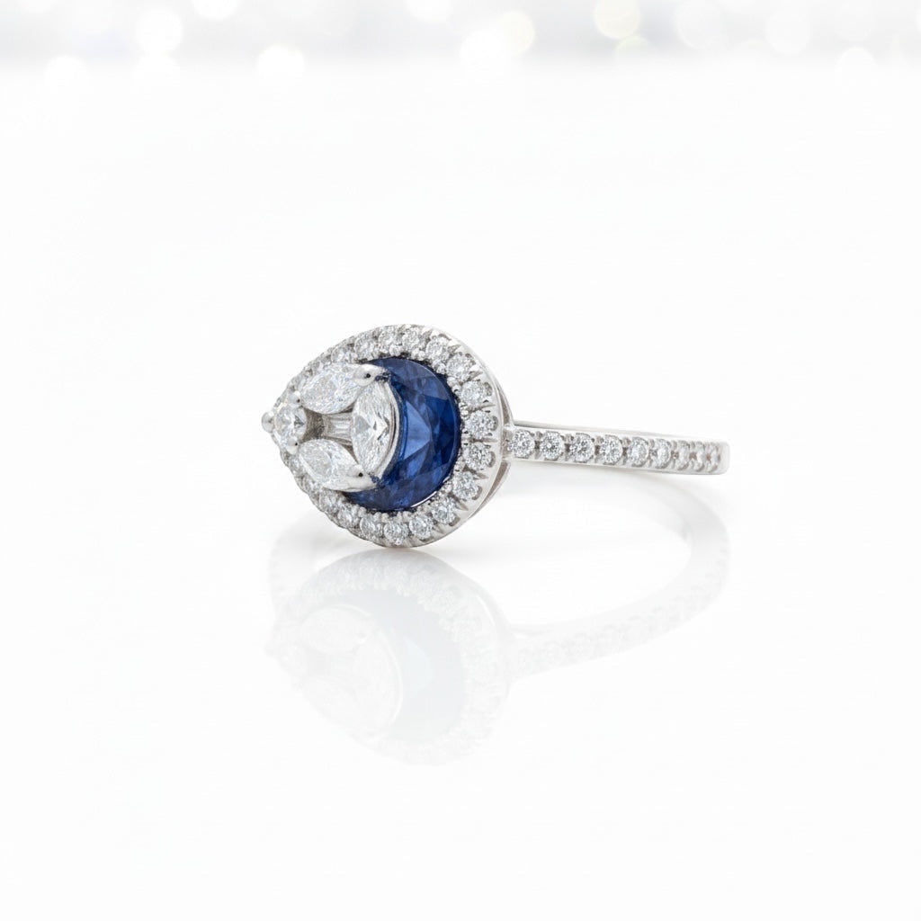 Maison Leininger 18K white gold ring with a central sapphire surrounded by marquise and round diamonds.