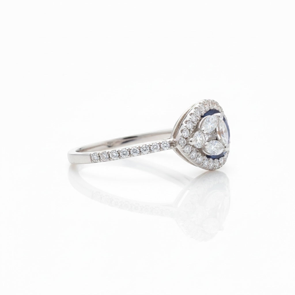 Maison Leininger 18K white gold ring with sapphire center surrounded by marquise and round diamonds.